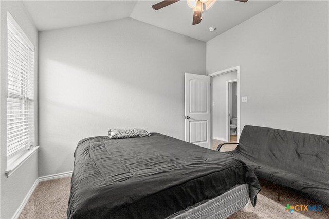 carpeted bedroom featuring lofted ceiling, multiple windows, baseboards, and a ceiling fan