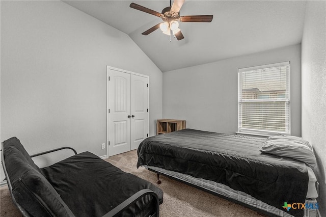carpeted bedroom featuring a closet, vaulted ceiling, and a ceiling fan