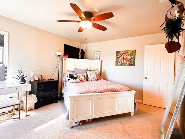 bedroom featuring light carpet and ceiling fan