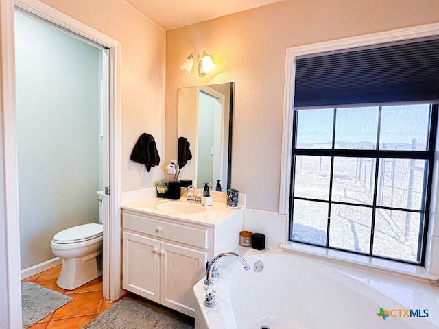 bathroom with tile patterned floors, toilet, vanity, and a washtub