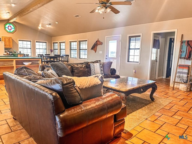 living room featuring a wealth of natural light, lofted ceiling with beams, and ceiling fan