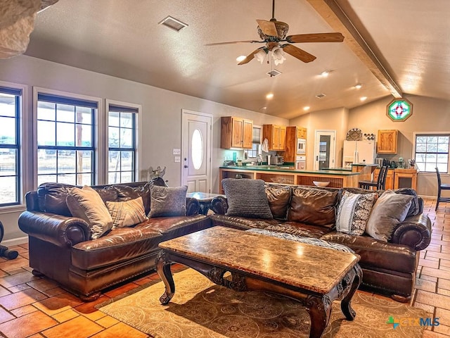 living room with lofted ceiling with beams and ceiling fan