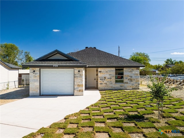 view of front of property featuring a garage and a front yard