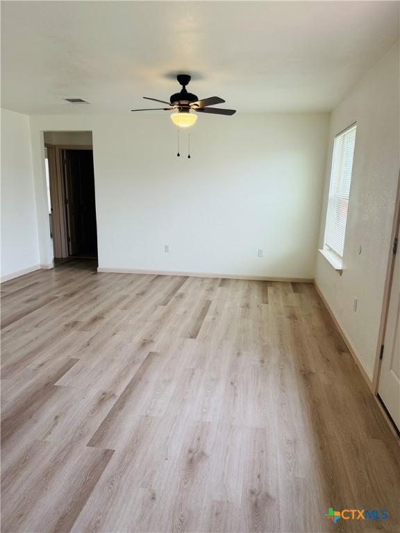 unfurnished room featuring ceiling fan and light hardwood / wood-style flooring