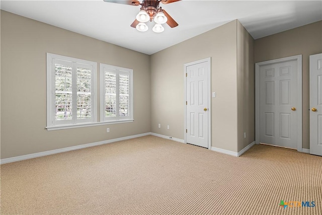 313 Treasure Oaks Rd, Inez, TX 77968 - unfurnished bedroom featuring light carpet, baseboards, and ceiling fan