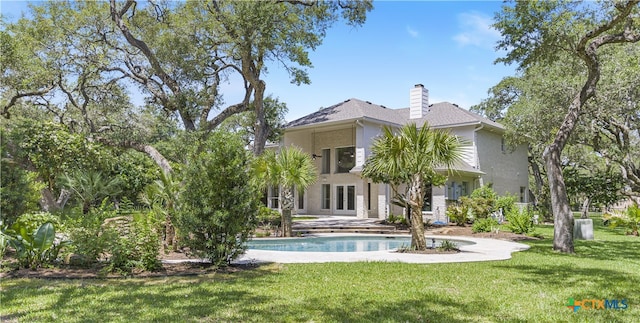 313 Treasure Oaks Rd, Inez, TX 77968 - rear view of property featuring french doors, a yard, and a chimney