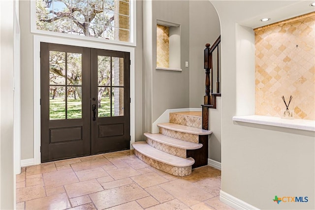 313 Treasure Oaks Rd, Inez, TX 77968 - entrance foyer with french doors, stairs, baseboards, stone tile flooring, and recessed lighting