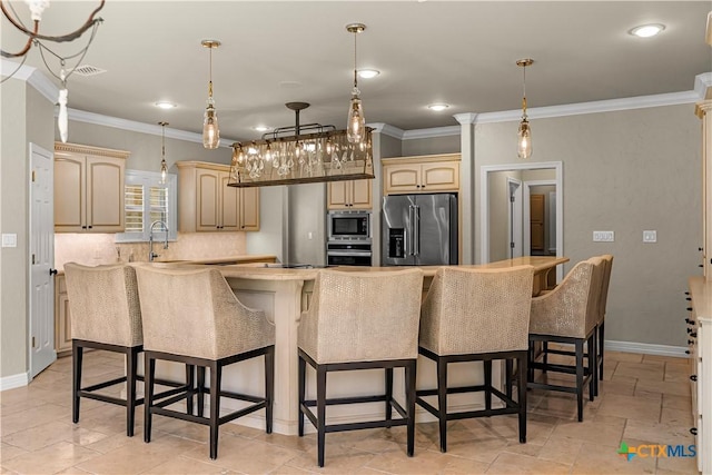 313 Treasure Oaks Rd, Inez, TX 77968 - kitchen with appliances with stainless steel finishes, crown molding, a center island, baseboards, and a kitchen bar
