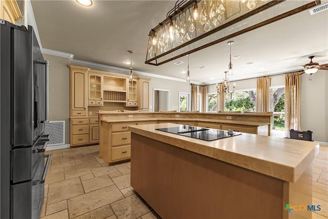 313 Treasure Oaks Rd, Inez, TX 77968 - kitchen with black appliances, a kitchen island, stone tile flooring, light brown cabinetry, and ornamental molding
