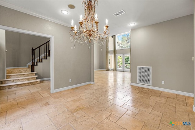 313 Treasure Oaks Rd, Inez, TX 77968 - unfurnished room with stone tile floors, baseboards, stairway, a chandelier, and ornamental molding