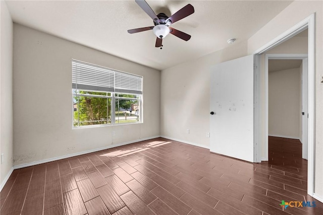 unfurnished room with a ceiling fan, baseboards, and wood finished floors