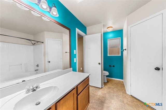 full bath featuring toilet, baseboards, and vanity