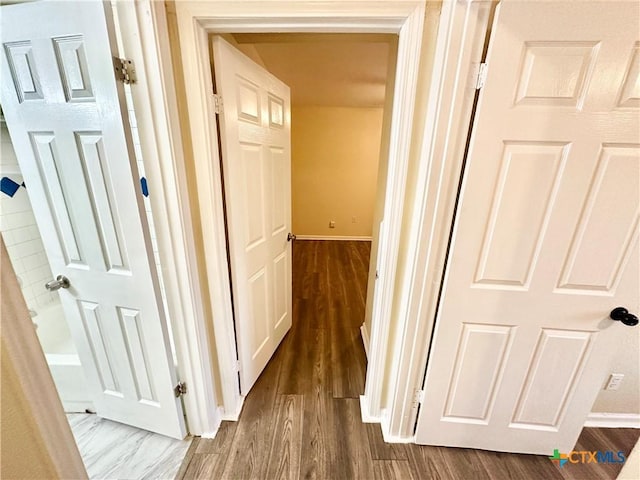 hall with dark wood-type flooring