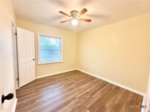 spare room with hardwood / wood-style flooring and ceiling fan