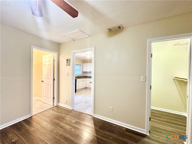 spare room featuring wood-type flooring and ceiling fan