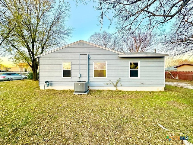 exterior space featuring cooling unit and a lawn