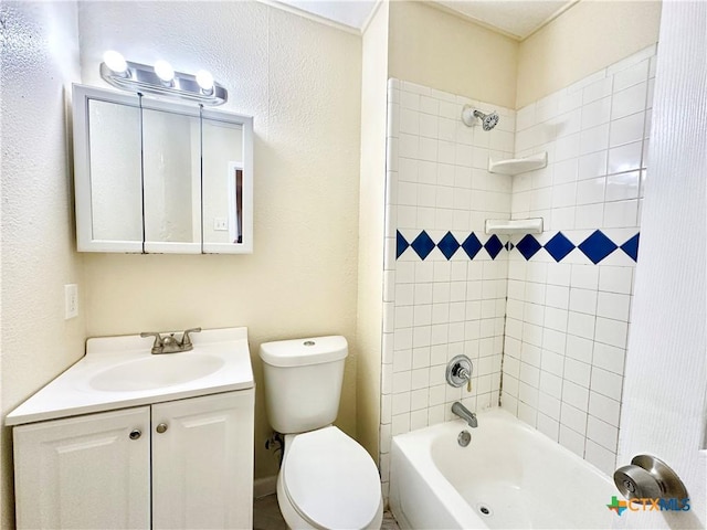 full bathroom with tiled shower / bath, vanity, and toilet