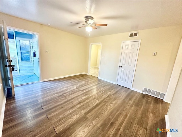 empty room with dark wood-type flooring and ceiling fan