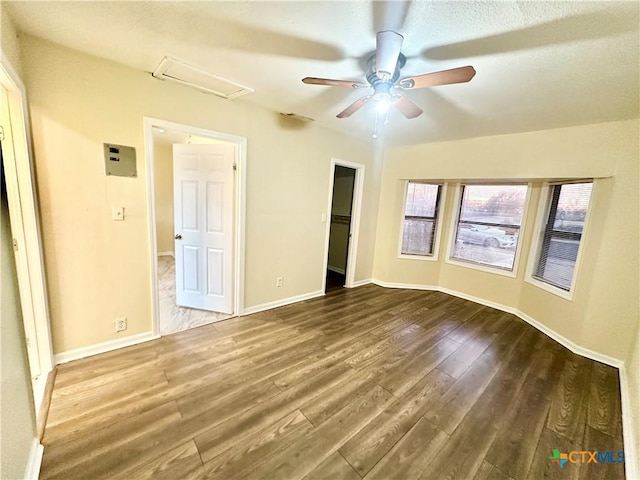 unfurnished bedroom featuring wood-type flooring, a walk in closet, ceiling fan, and a closet