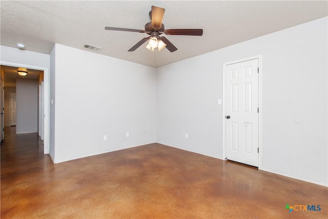 unfurnished room with a textured ceiling, ceiling fan, visible vents, and finished concrete flooring