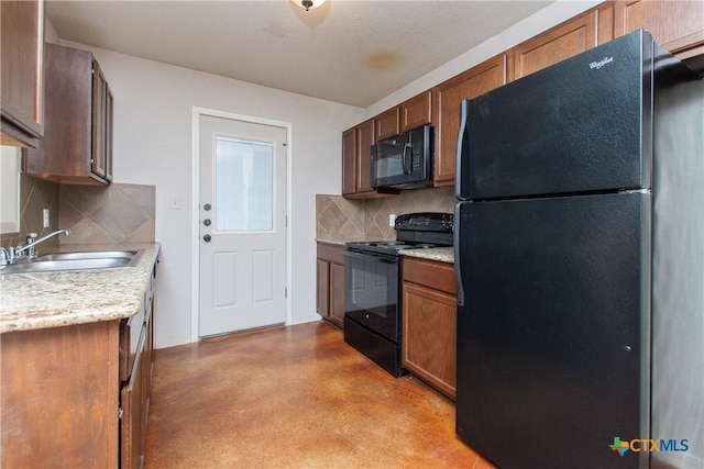 kitchen with black appliances, backsplash, a sink, and light countertops