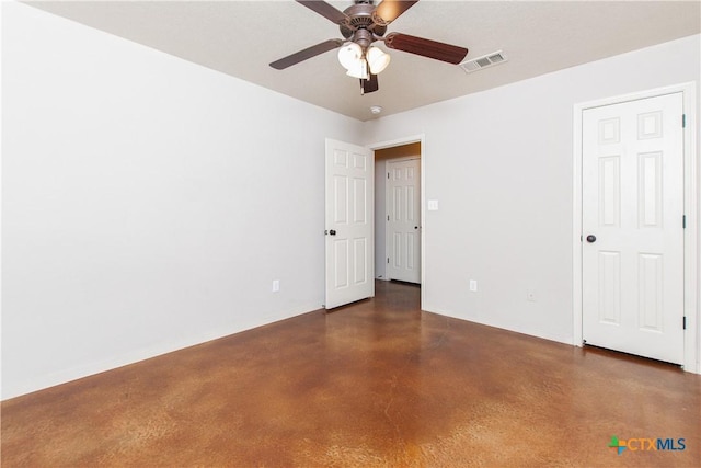 unfurnished room featuring a ceiling fan, visible vents, and finished concrete flooring