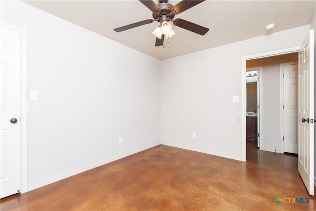 unfurnished room with ceiling fan and finished concrete floors