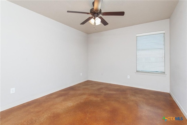 empty room featuring a ceiling fan and finished concrete flooring