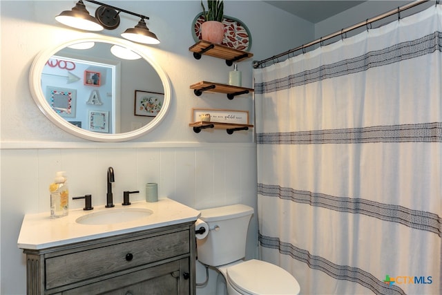 bathroom with toilet, vanity, and walk in shower