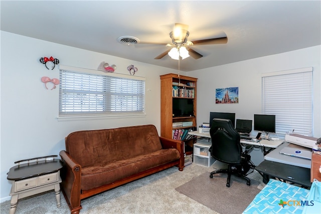 home office featuring light carpet and ceiling fan