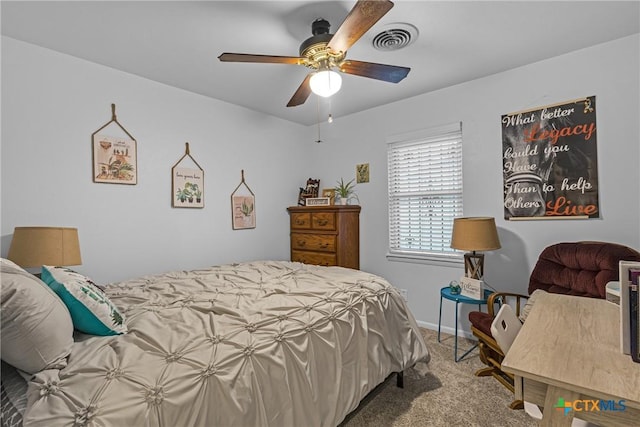 carpeted bedroom with ceiling fan, visible vents, and baseboards