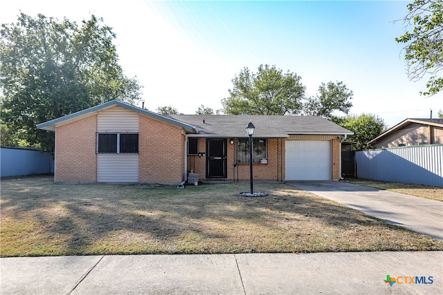 ranch-style home with a garage, concrete driveway, fence, a front lawn, and brick siding