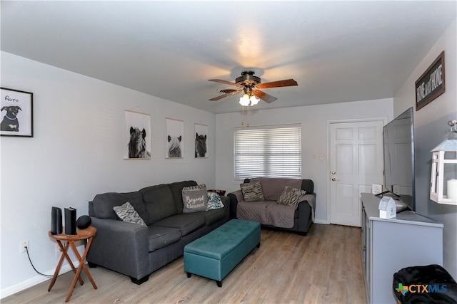 living room featuring light wood-type flooring and ceiling fan