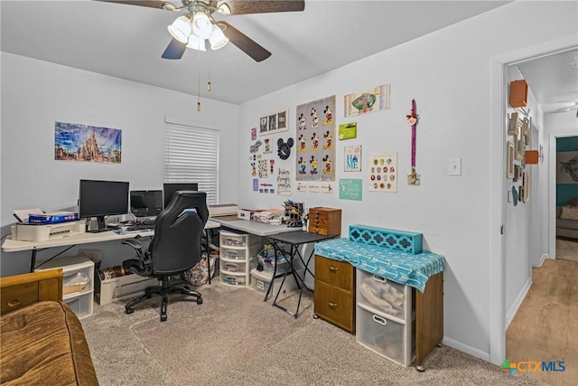 office featuring a ceiling fan and baseboards