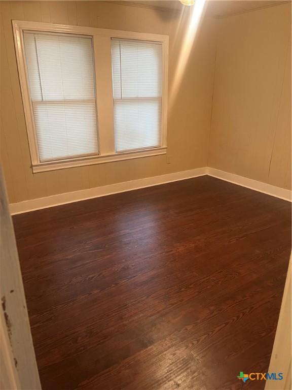 empty room featuring dark hardwood / wood-style flooring