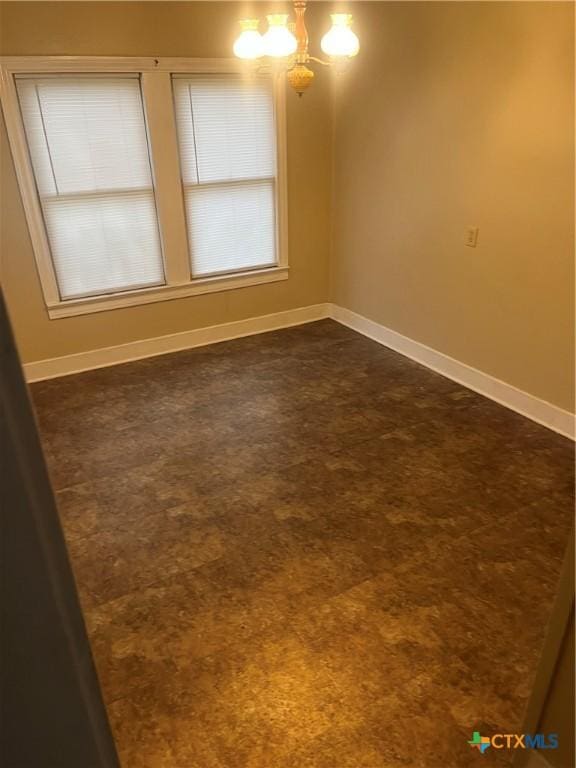 empty room with a notable chandelier