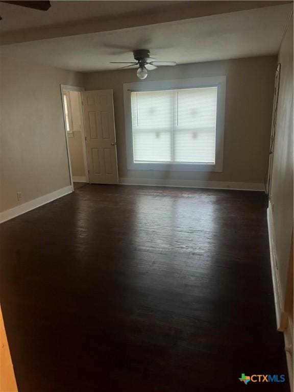 unfurnished room with dark hardwood / wood-style flooring and ceiling fan