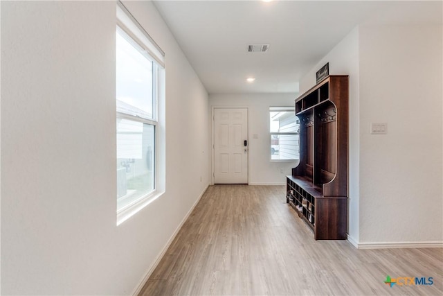 mudroom with visible vents, light wood-style flooring, and baseboards