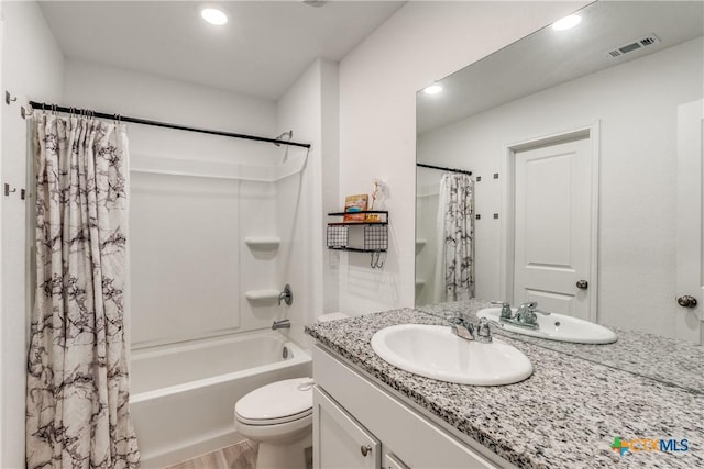 full bathroom with shower / tub combo, visible vents, vanity, and toilet