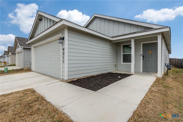 single story home featuring board and batten siding, concrete driveway, and a garage