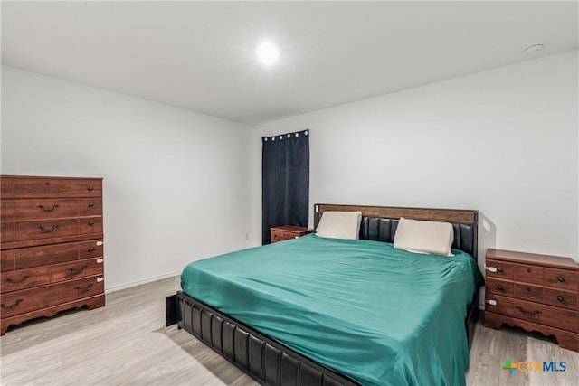 bedroom with wood finished floors and baseboards