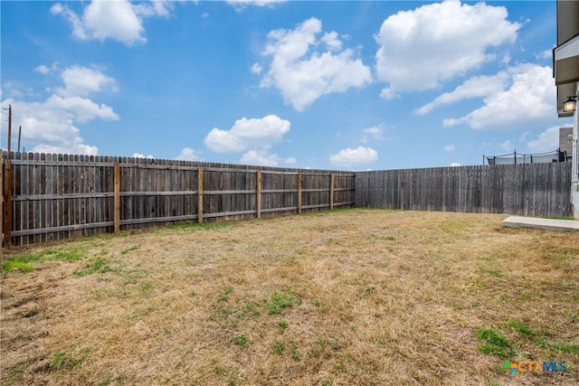 view of yard with a fenced backyard