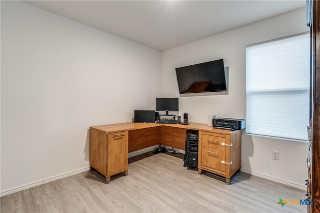 office area with light wood-style floors and baseboards