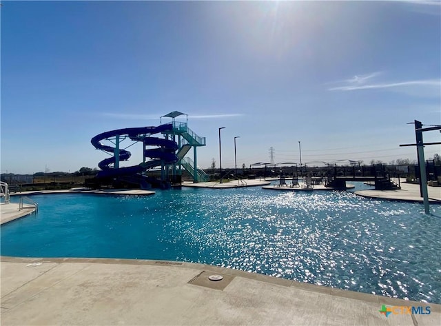 community pool featuring a water slide