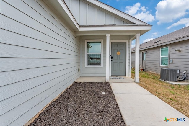 property entrance with central AC and board and batten siding