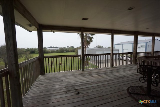 wooden terrace featuring a lawn