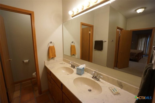 bathroom featuring vanity, tile patterned flooring, and toilet