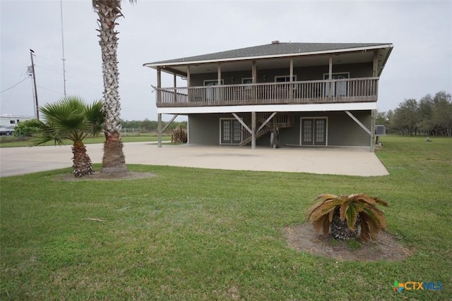 back of house with a patio and a yard