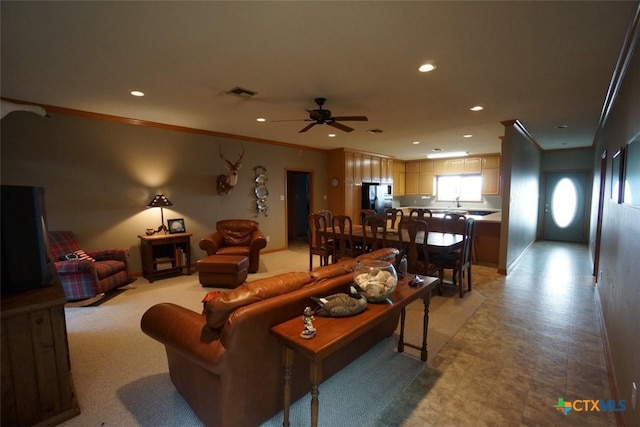 living room with crown molding and ceiling fan