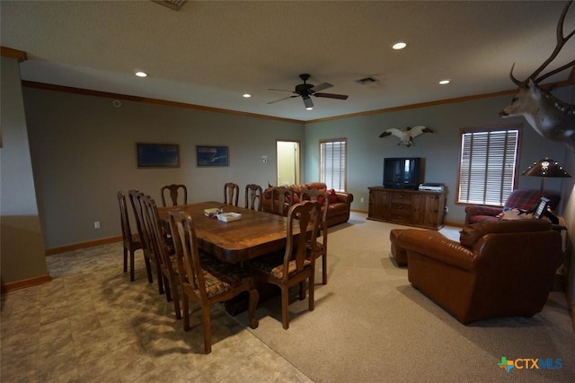 dining space with crown molding and ceiling fan